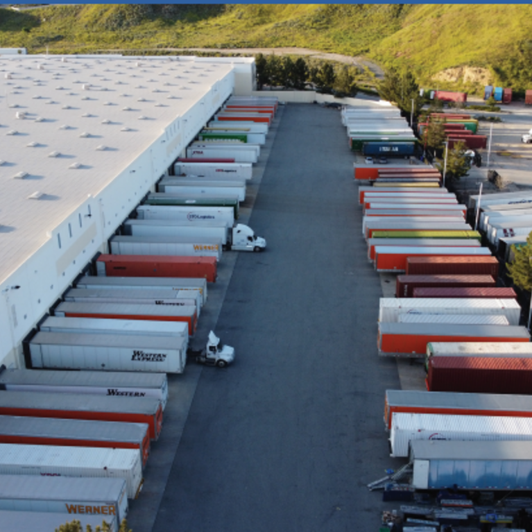 warehouse with semi-trucks outside