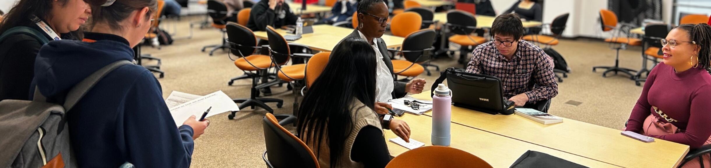 Researchers in a room sitting and talking