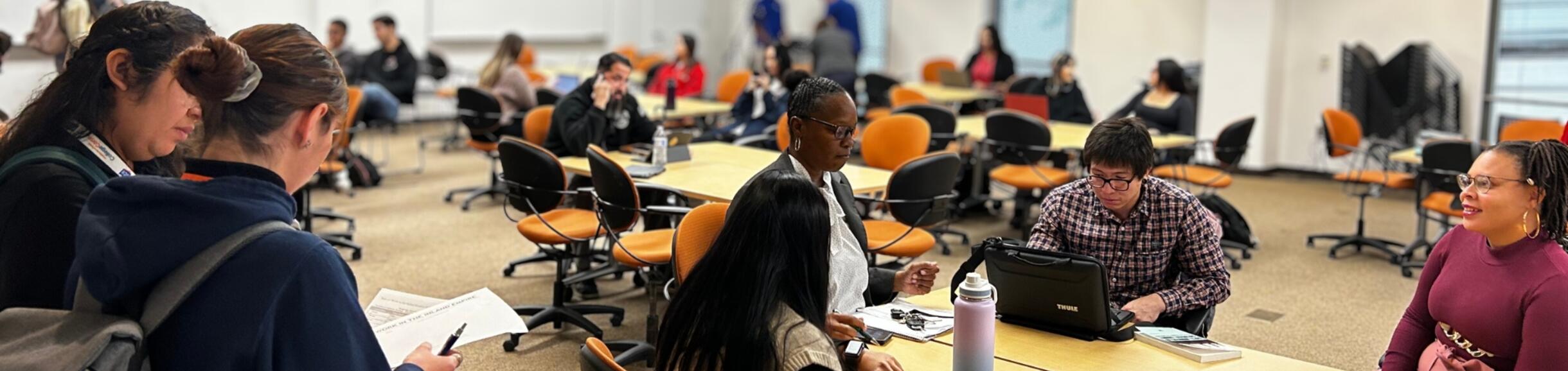 Researchers in a room sitting and talking