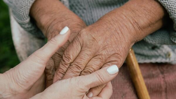 holding hands young person and elder